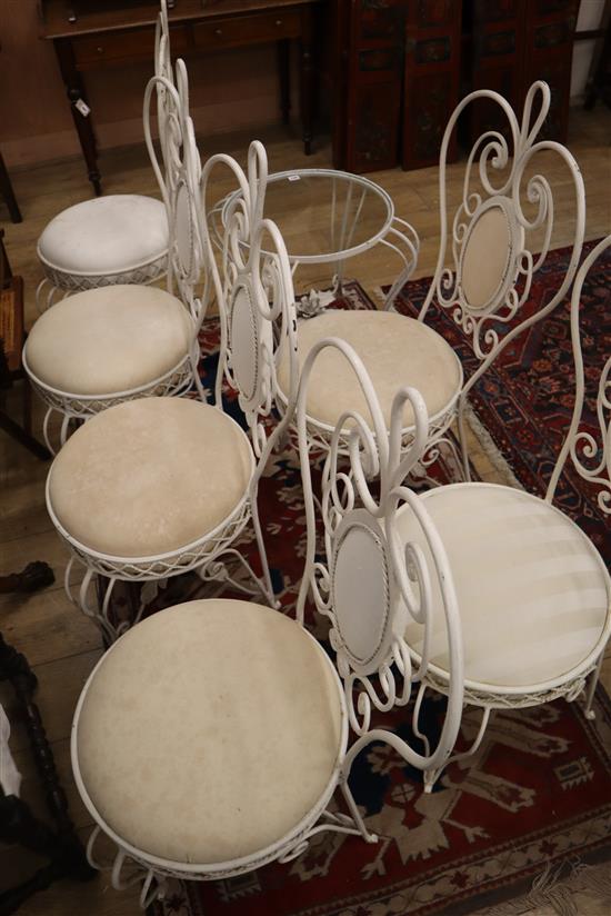 A set of six wrought iron chairs and a matching circular table Table 66cm diameter